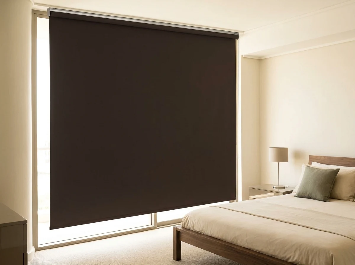 Espresso brown blockout roller blind fully lowered in a Green Point apartment bedroom, no folds or pleats